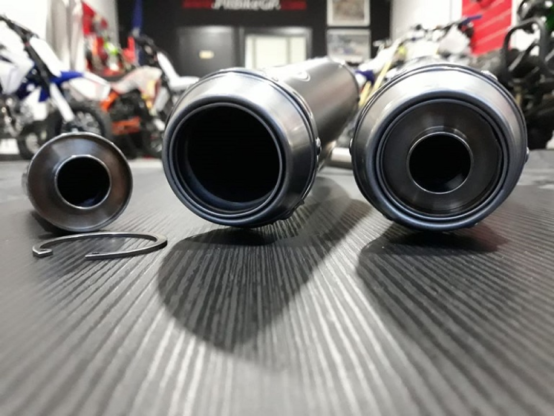 Several disassembled exhaust pipes showing dB-killer
